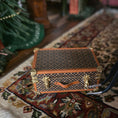 Load image into Gallery viewer, Miniature patterned suitcase on a textured surface
