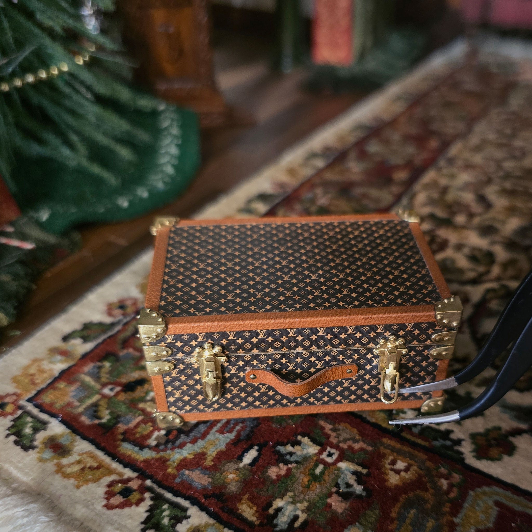 Miniature patterned suitcase on a textured surface