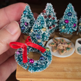 Load image into Gallery viewer, Decorative Christmas tree ornament with a red ribbon on a miniature table setting.
