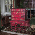 Load image into Gallery viewer, Red wooden dresser with intricate carvings in a vintage room setting. Alan Barnes
