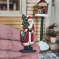Load image into Gallery viewer, Miniature Folk Art Santa Figurine – Signed Richards 1981 held in a hand
