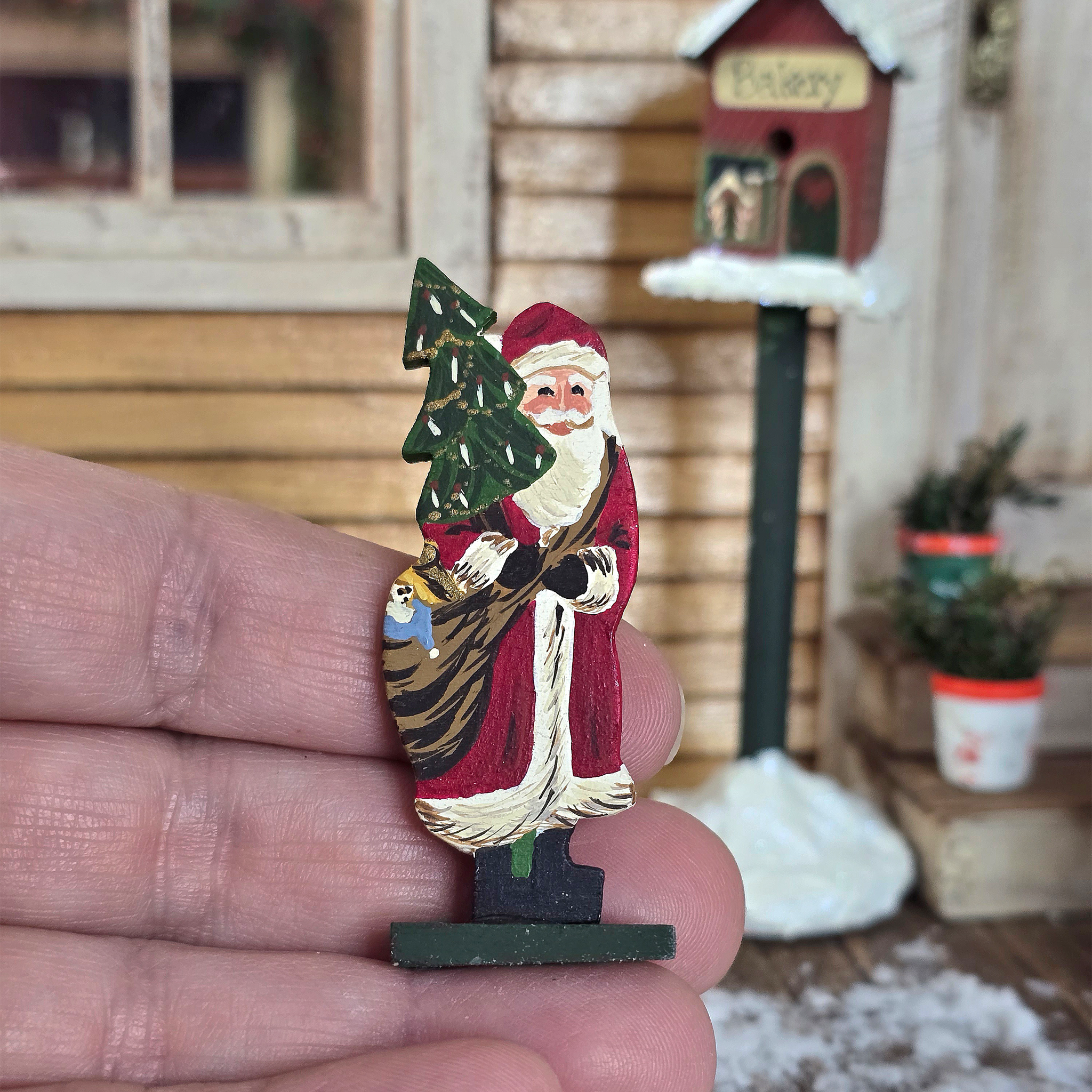 Miniature Folk Art Santa Figurine – Signed Richards 1981 held in a hand