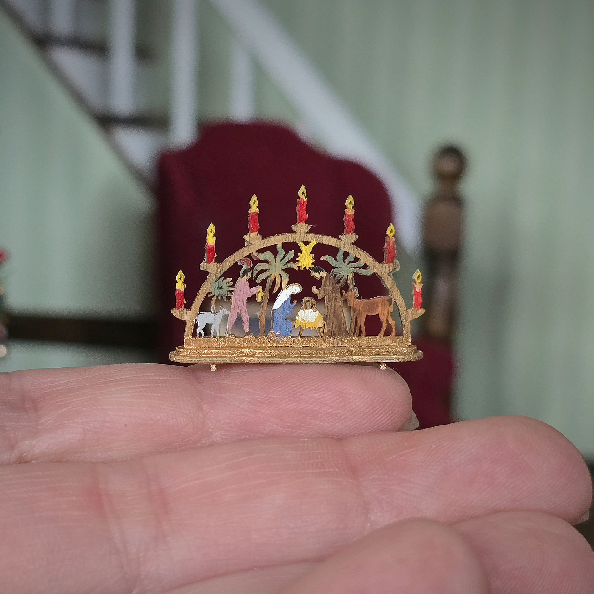 Miniature Schwibbogen Nativity Scene – Hand-Carved Wood held in a hand