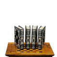 Load image into Gallery viewer, Set of four ornate books on a wooden stand with a white background
