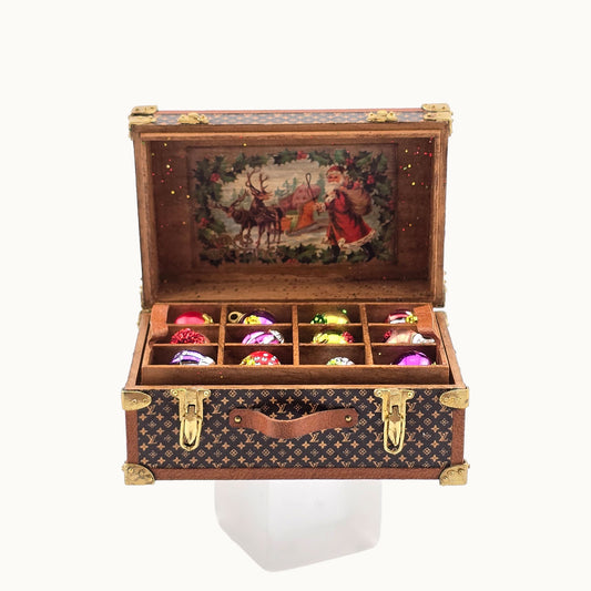 Decorative miniature Christmas ornament box with a vintage design on a white background