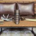 Load image into Gallery viewer, Decorative book on a wooden table in a living room setting.
