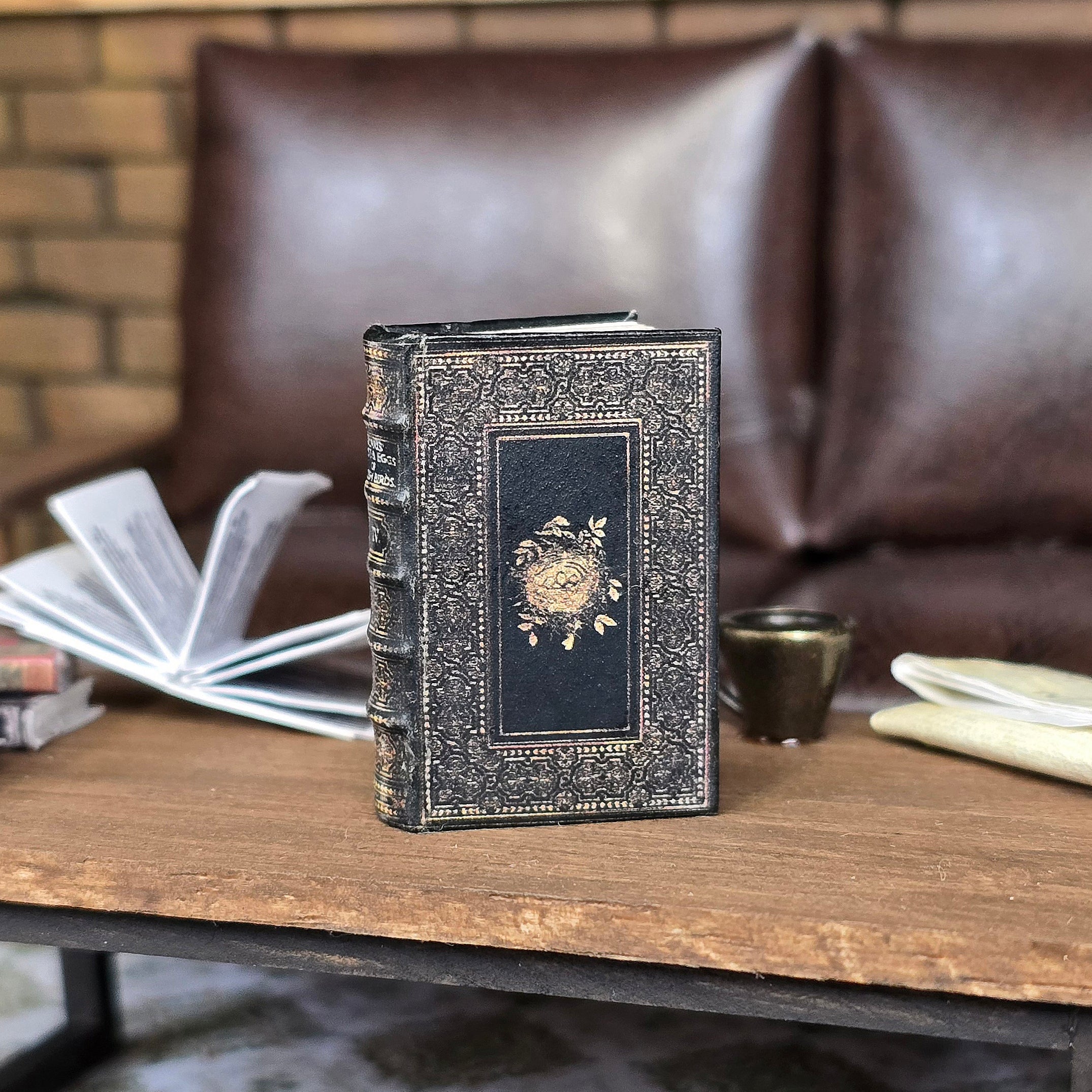Decorative book with intricate design on a wooden table with a blurred background