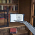 Load image into Gallery viewer, book held open with tweezers
