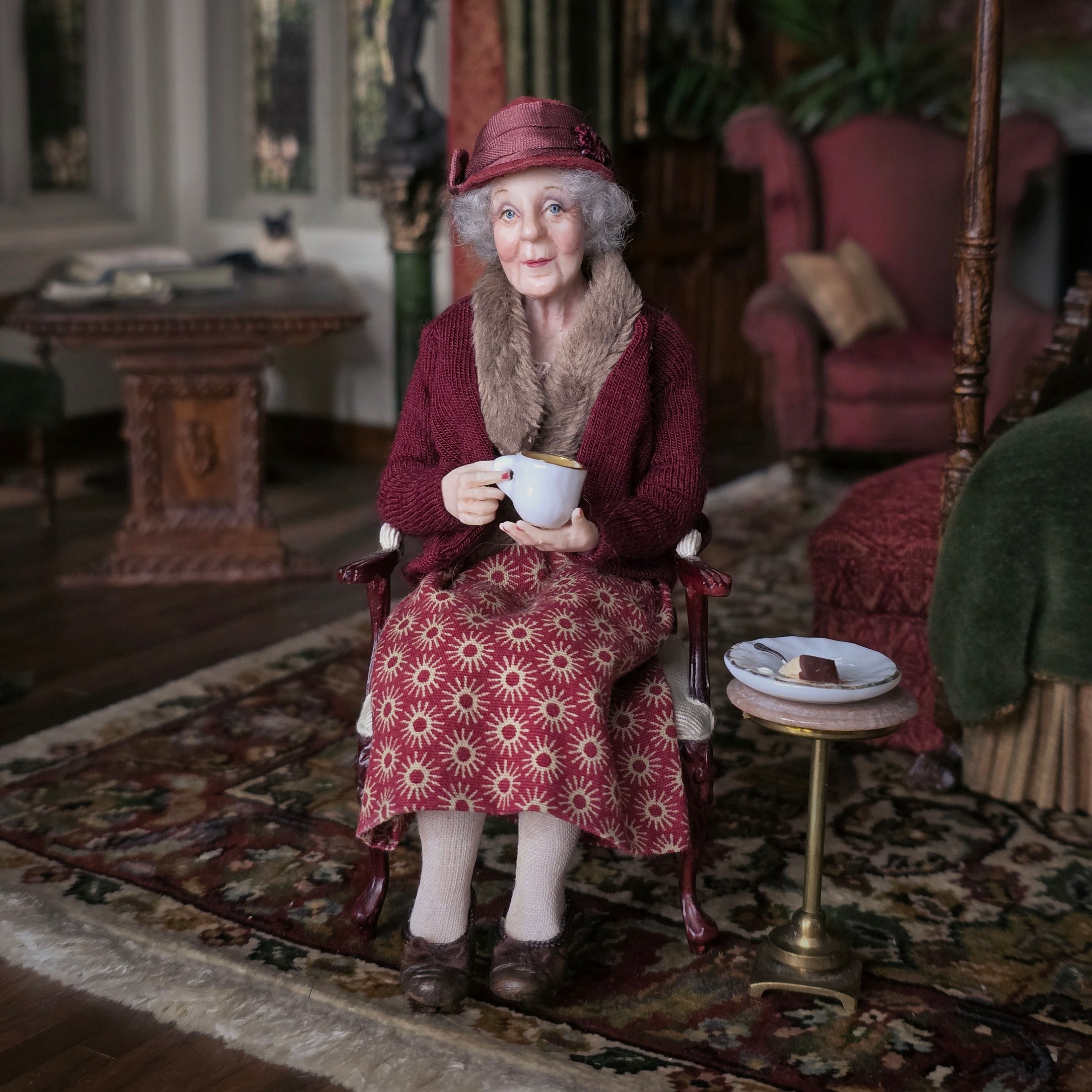 Julie Campbell IGMA Seated Elder Lady Doll in Burgundy Coat Clay Character Figure