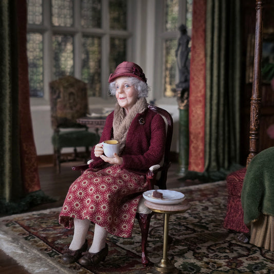 Julie Campbell IGMA Seated Elder Lady Doll in Burgundy Coat Clay Character Figure