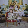 Load image into Gallery viewer, Seated Porcelain Little Girl Doll with Teacup, Pink Feathered Hat & Leather Shoes
