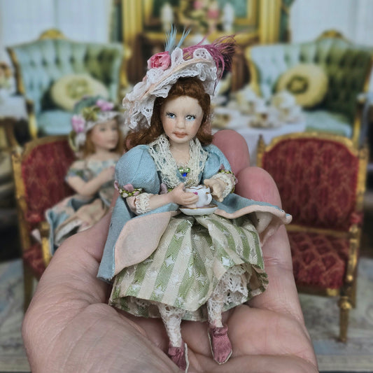 Seated Porcelain Little Girl Doll with Teacup, Pink Feathered Hat & Leather Shoes