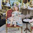 Load image into Gallery viewer, Seated Porcelain Little Girl Doll with Teacup, Green Silk Hat & Leather Shoes
