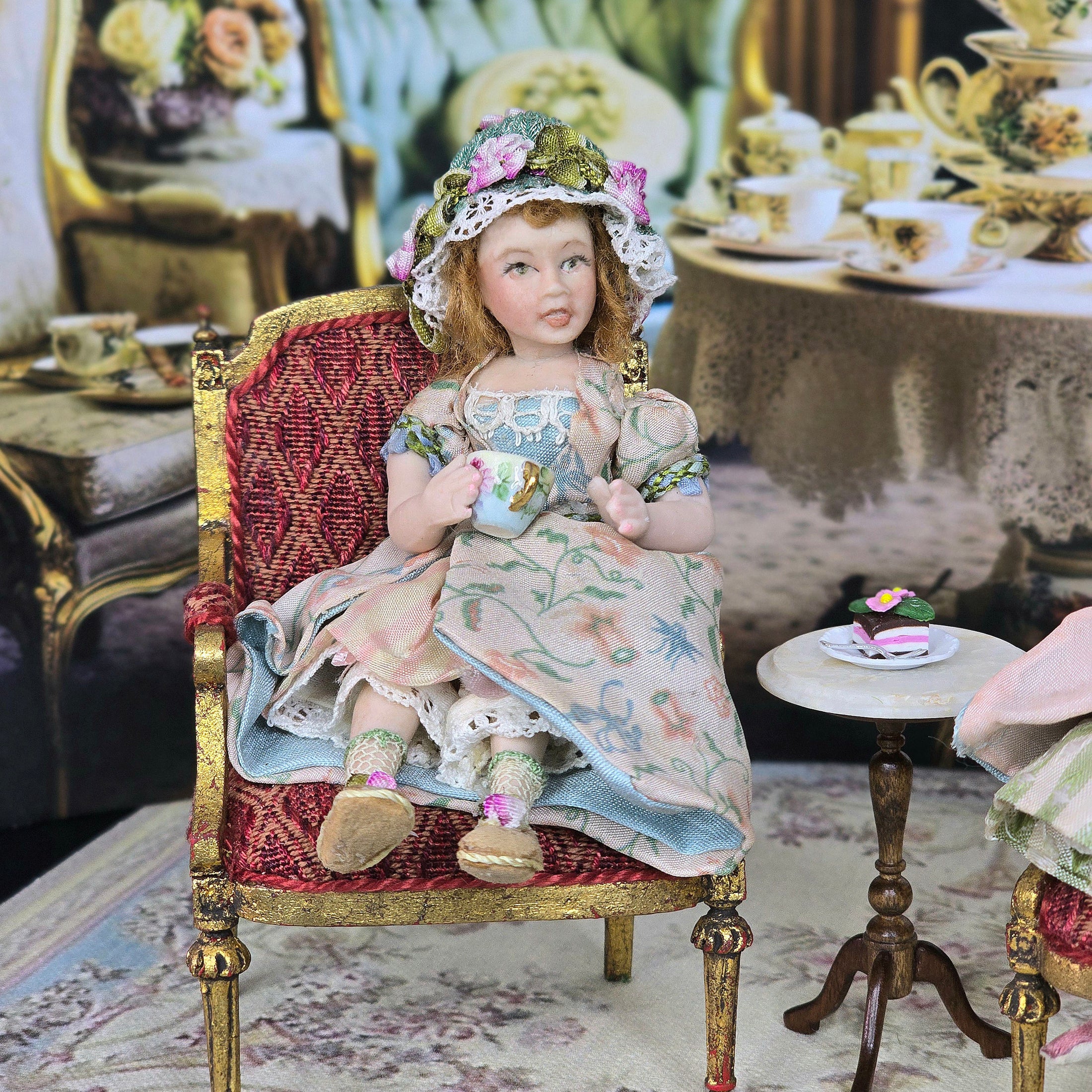 Seated Porcelain Little Girl Doll with Teacup, Green Silk Hat & Leather Shoes