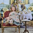 Load image into Gallery viewer, Seated Porcelain Little Girl Doll with Teacup, Green Silk Hat & Leather Shoes
