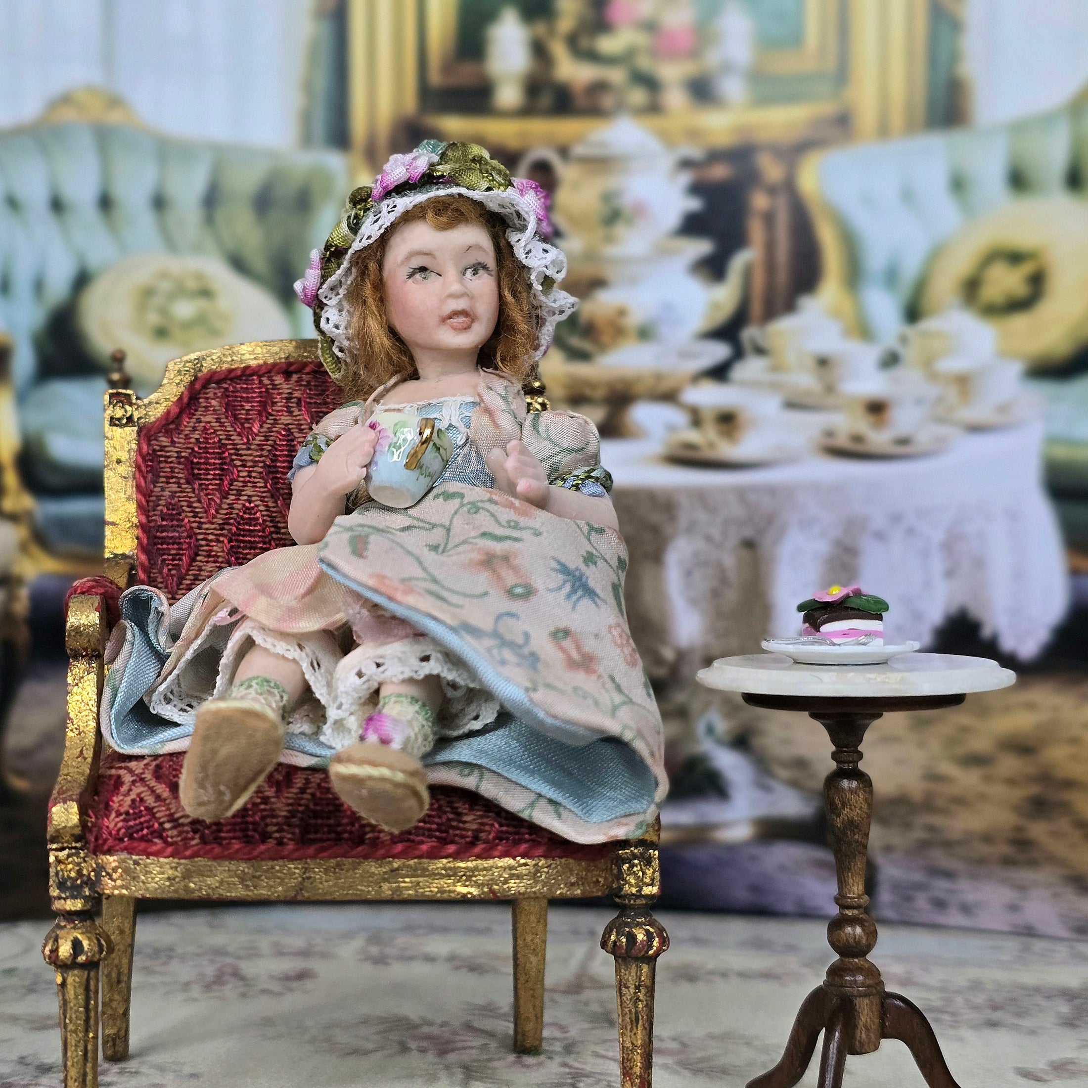 Seated Porcelain Little Girl Doll with Teacup, Green Silk Hat & Leather Shoes