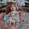 Load image into Gallery viewer, Seated Porcelain Little Girl Doll with Teacup, Green Silk Hat & Leather Shoes
