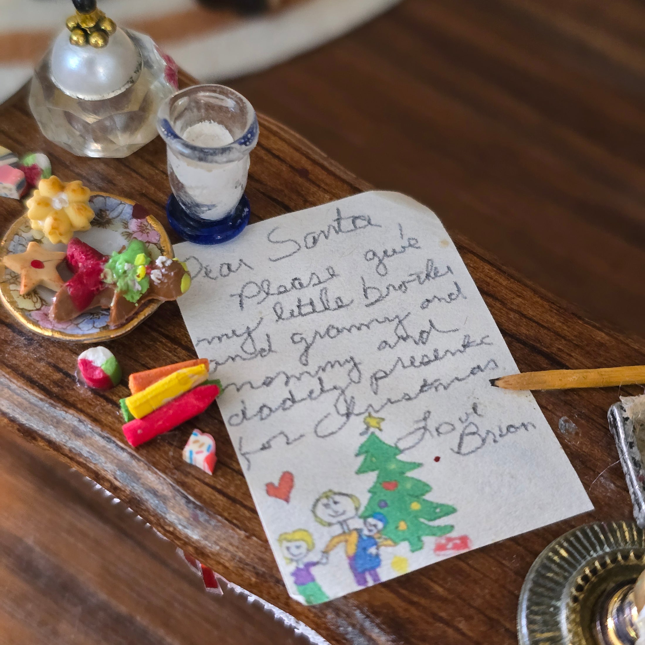Letter to Santa with Christmas-themed cookies on a wooden surface