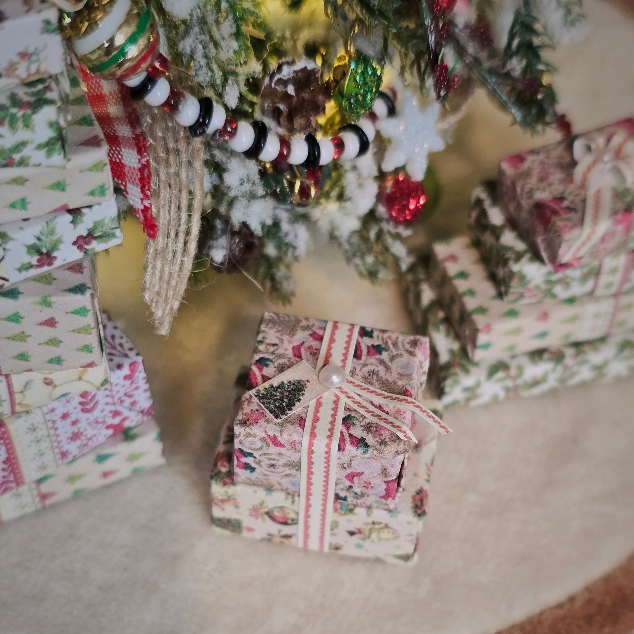 Decorative Christmas presents under a tree with ornaments.