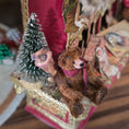 Load image into Gallery viewer, Small teddy bear and Christmas tree ornament hanging from a decorative box.
