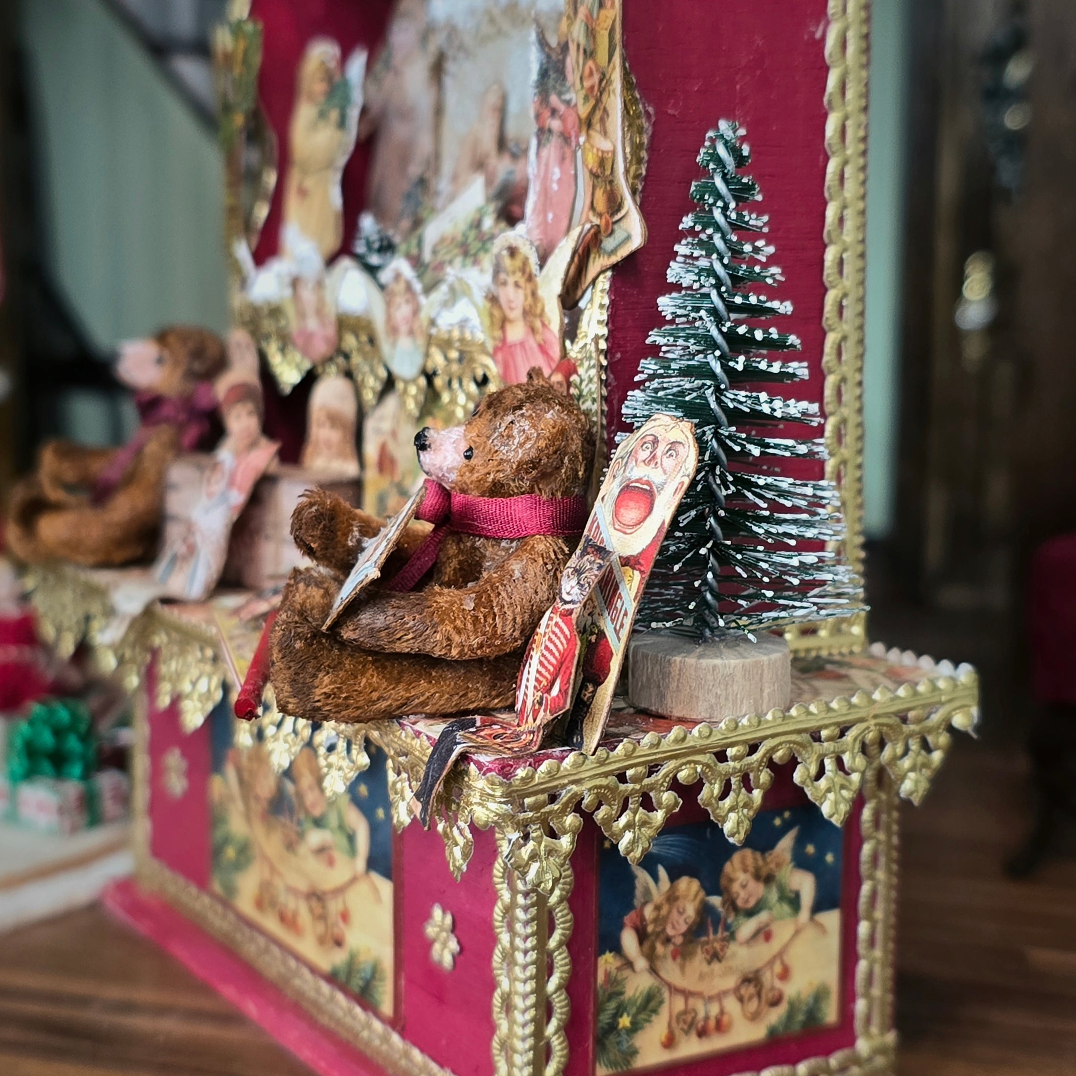 Decorative scene with a teddy bear, Christmas tree, and vintage-style packaging.
