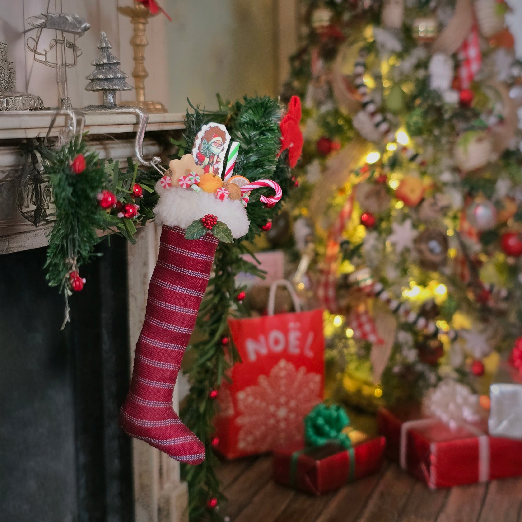 Christmas stocking hanging by a fireplace with a decorated tree in the background
