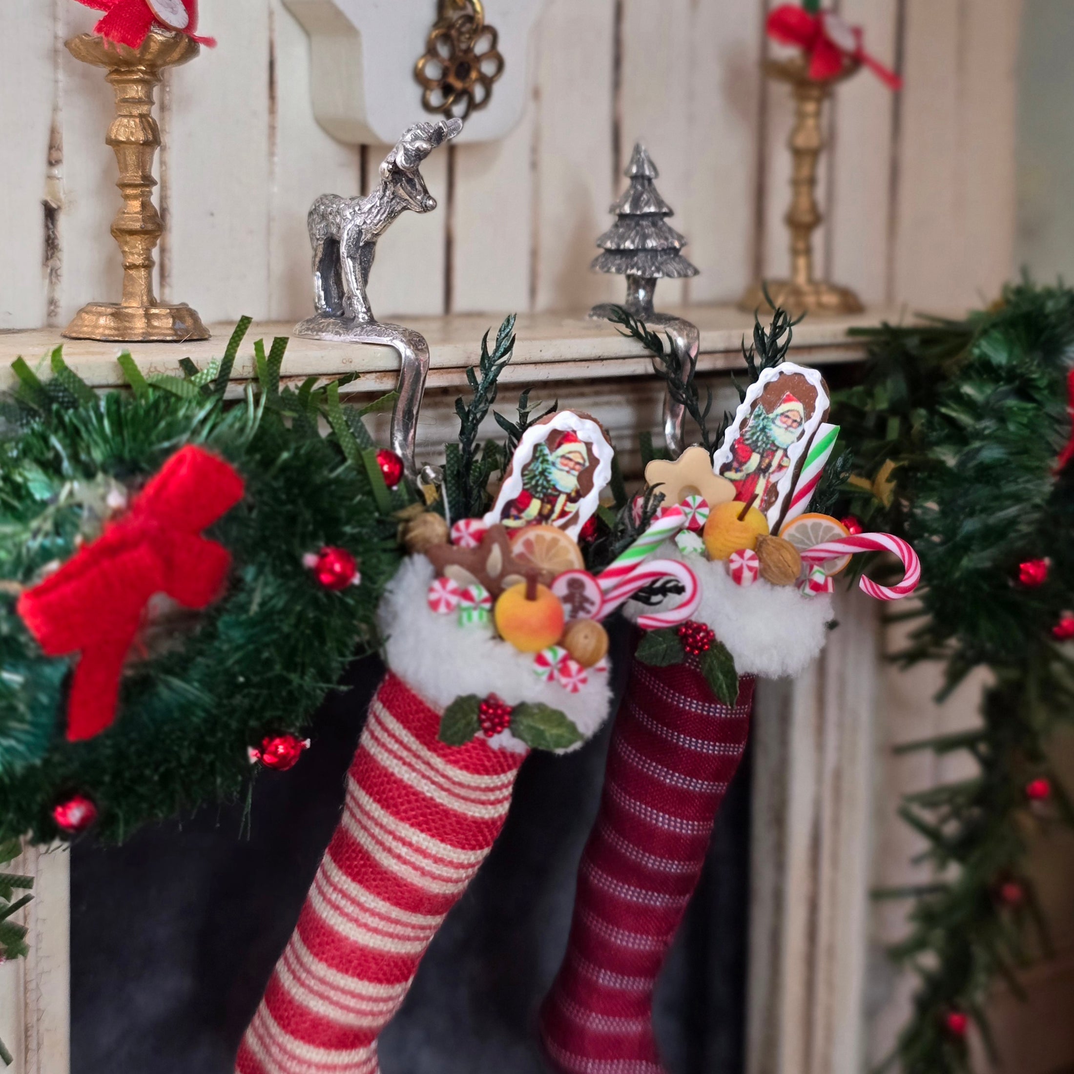 Decorative Christmas stockings with festive designs on a decorated fireplace mantel.