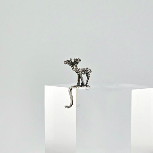 Miniature sterling reindeer stocking holder on a white background