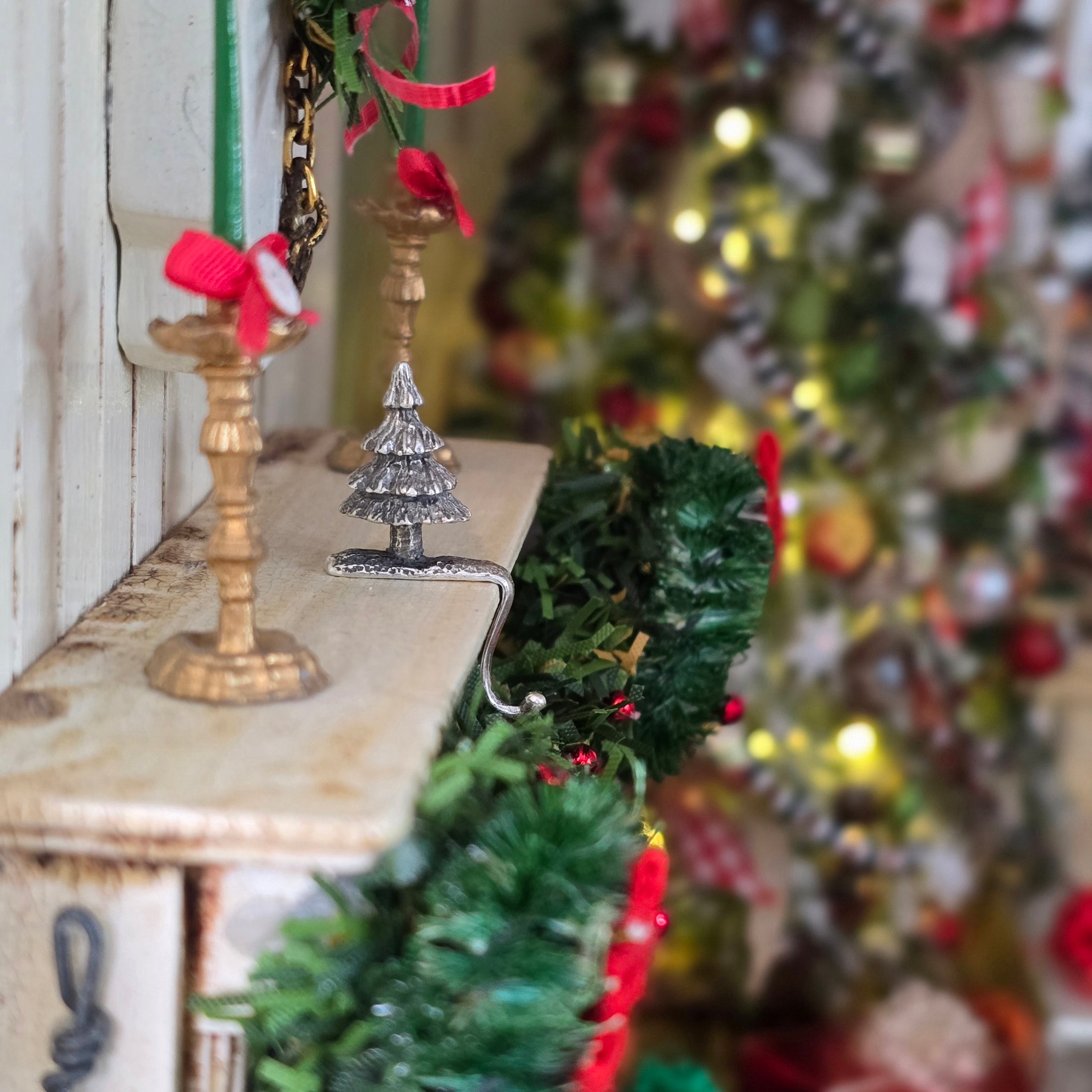 side view of sterling silver Christmas tree stocking holder on mantelpiece 