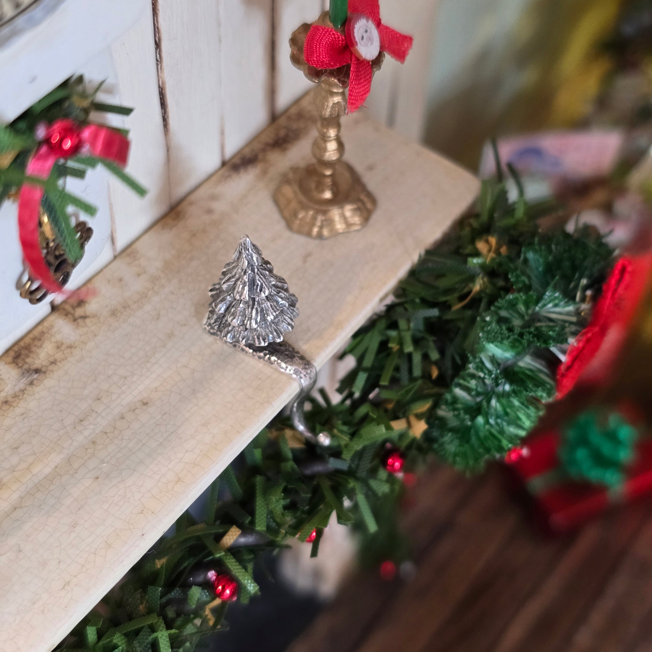 top view of sterling silver Christmas tree stocking holder on mantel