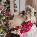 Load image into Gallery viewer, Mrs. Claus miniature doll in a red dress holding cookies in a festive setting with a Christmas tree.
