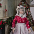 Load image into Gallery viewer, Mrs. Claus miniature doll in a red dress with white lace details, standing in a decorated room.
