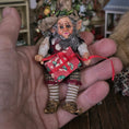 Load image into Gallery viewer, Small elf doll held in a hand with a blurred background
