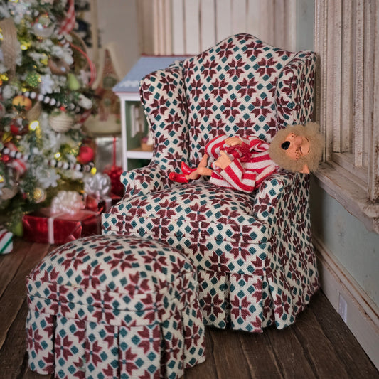 Yawning elf doll in armchair, Christmas tree in the background