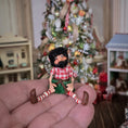 Load image into Gallery viewer, black-bearded elf dollhouse doll held in a hand
