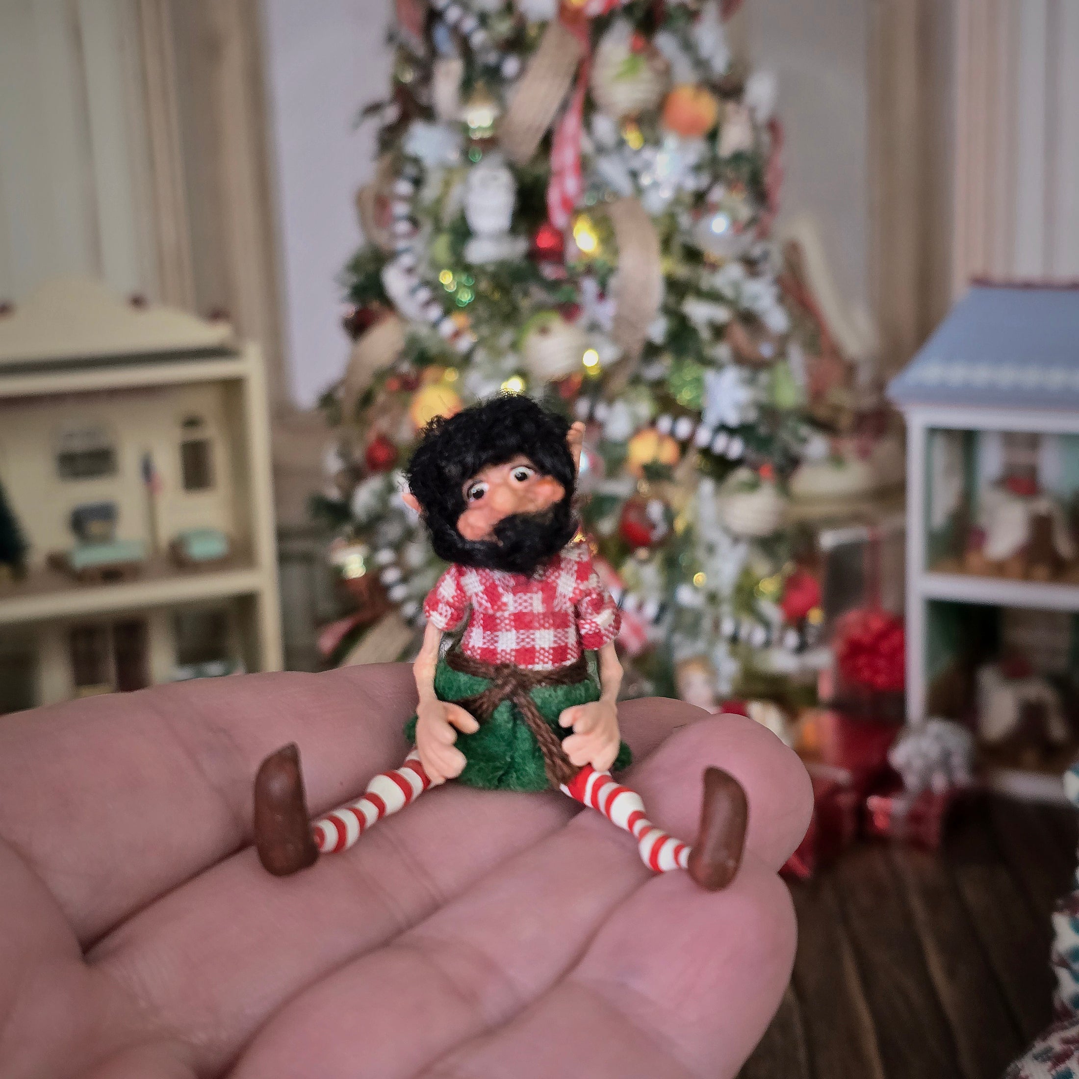 black-bearded elf dollhouse doll held in a hand