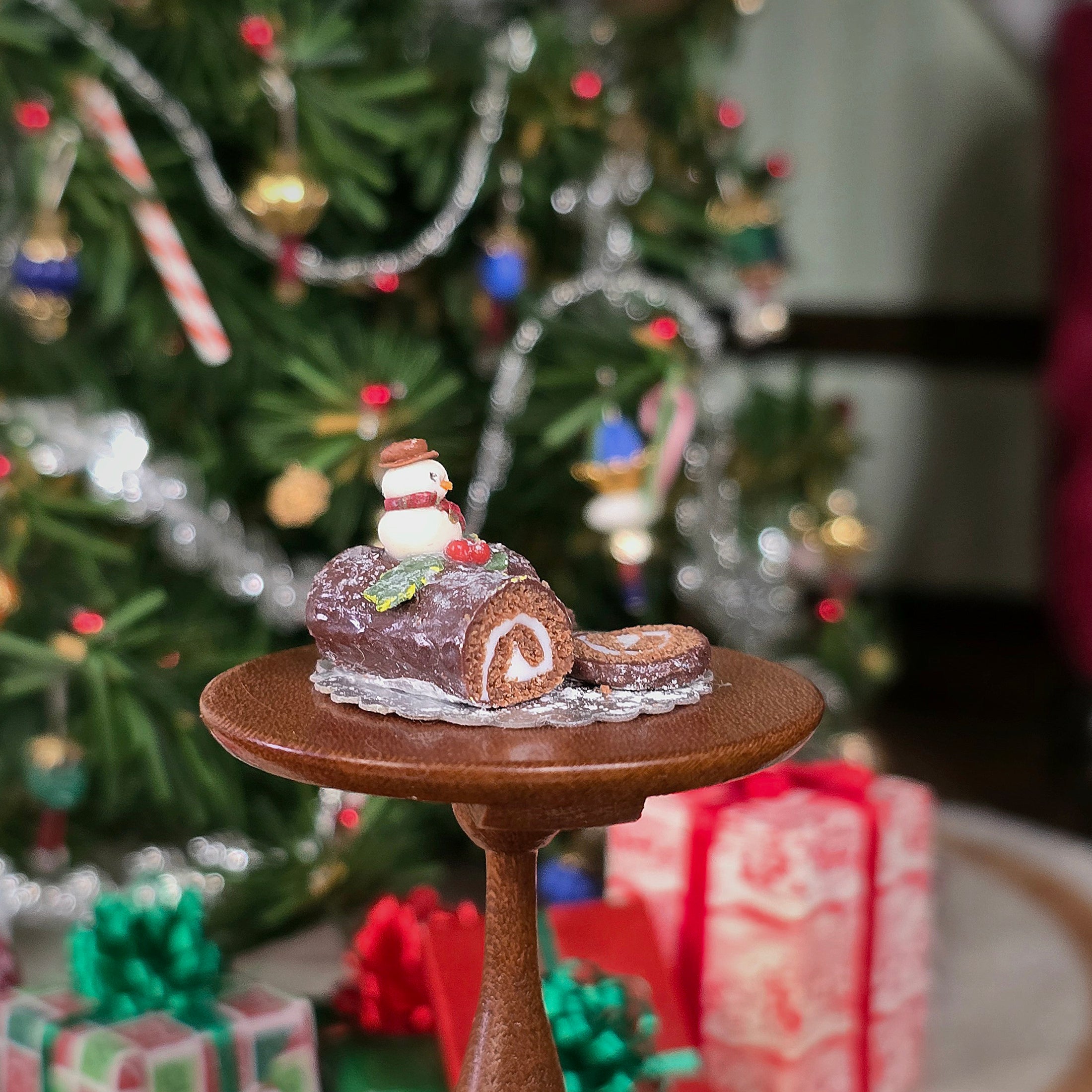 chocolate roll miniature cake with snowman on top