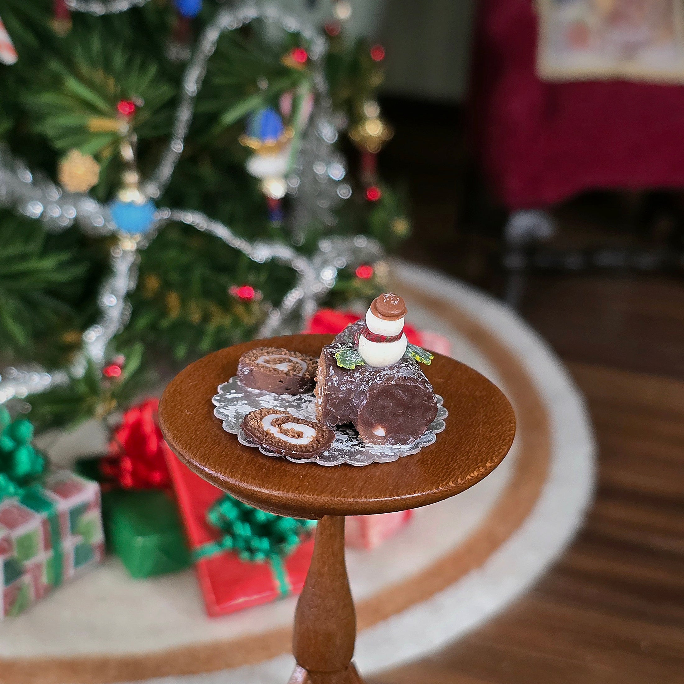 chocolate roll miniature cake with snowman on top, back view