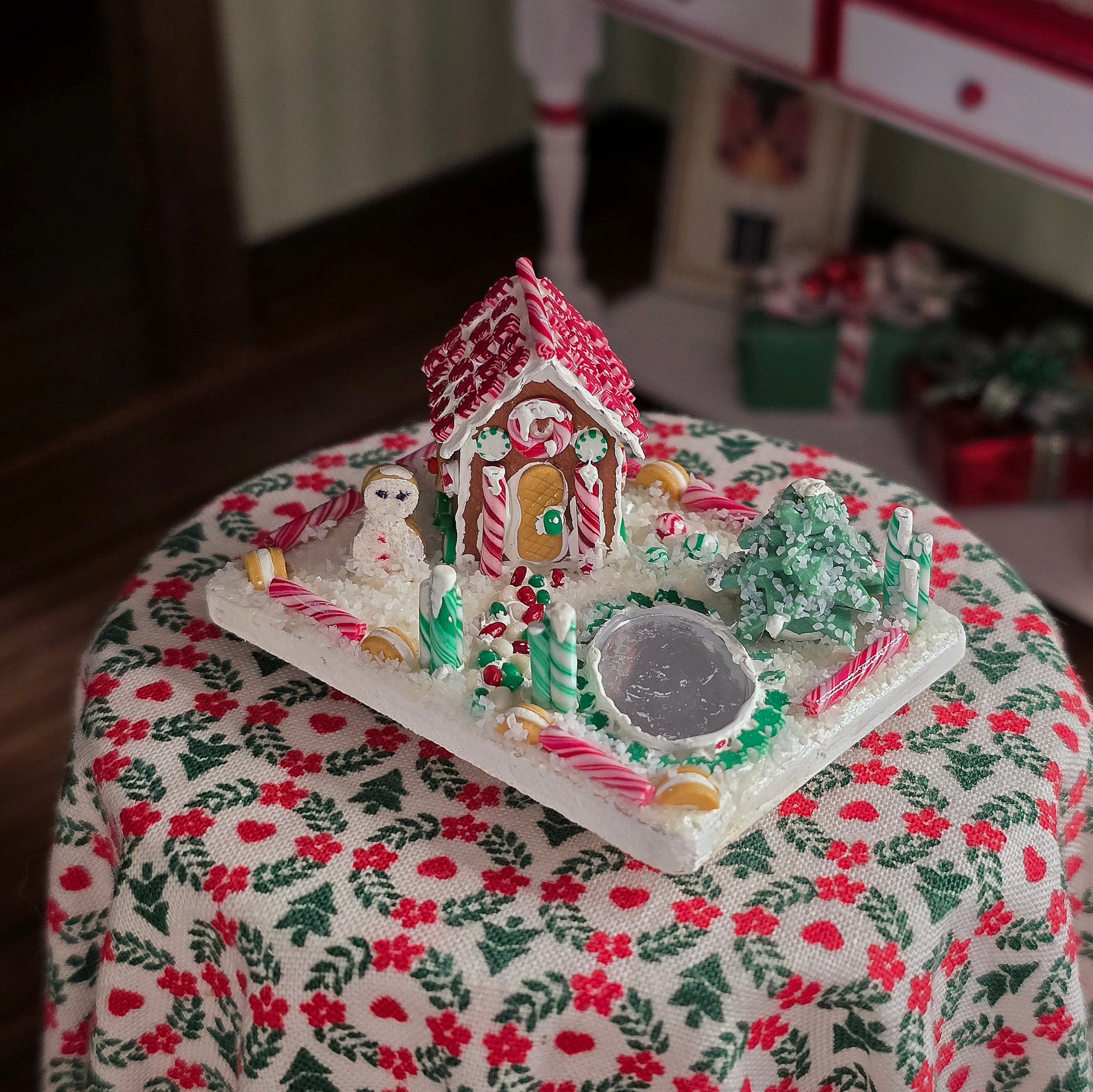 Decorative gingerbread house on a tablecloth with a blurred background