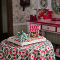 Load image into Gallery viewer, Gingerbread house and candy canes on a floral tablecloth with a decorative background
