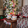 Load image into Gallery viewer, Pair of miniature hot cocoa cups with cream and biscotti in festive room, on table

