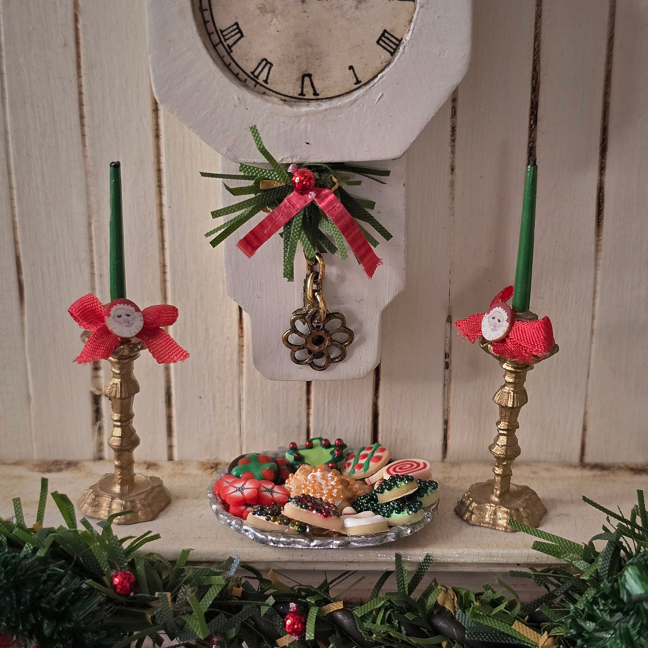 miniature dollhouse cookies on platter on fireplace mantel