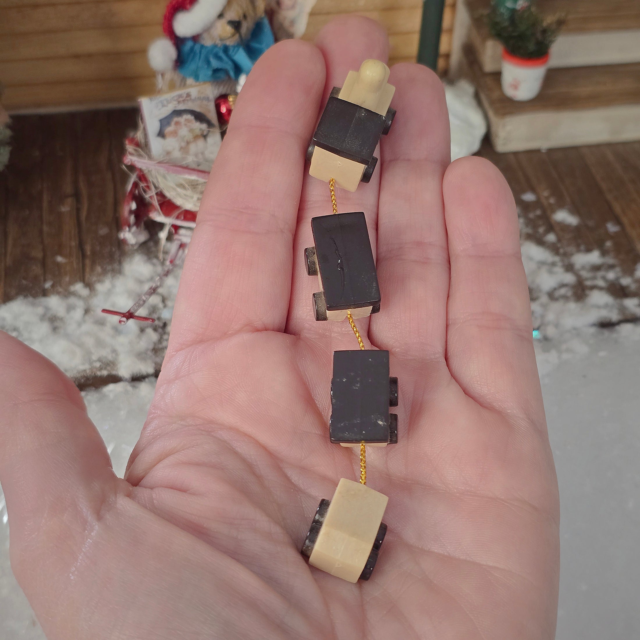 resin miniature toy train, in a hand for scale