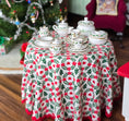 Load image into Gallery viewer, Miniature Christmas tea set on a table with a floral tablecloth in a festive setting.
