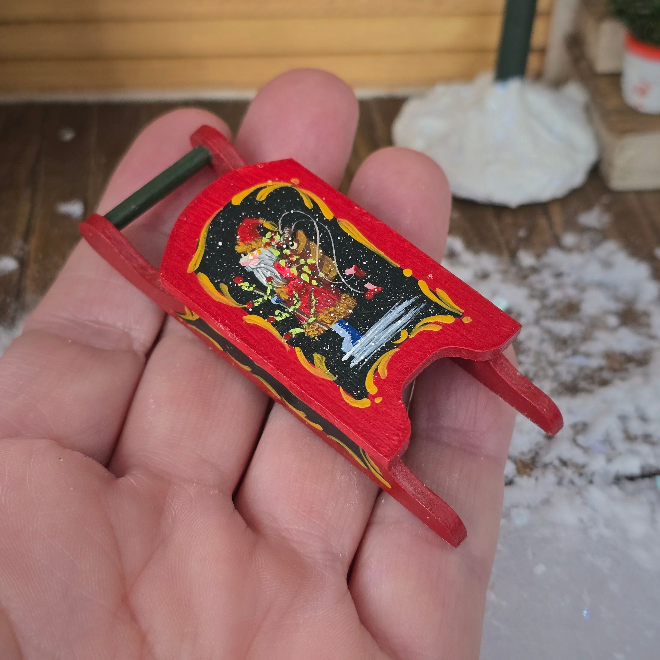 Miniature Christmas Sled – Hand-Painted by Pam Scott held in a hand