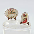 Load image into Gallery viewer, Two decorative dollhouse plates with festive designs on stands against a white background
