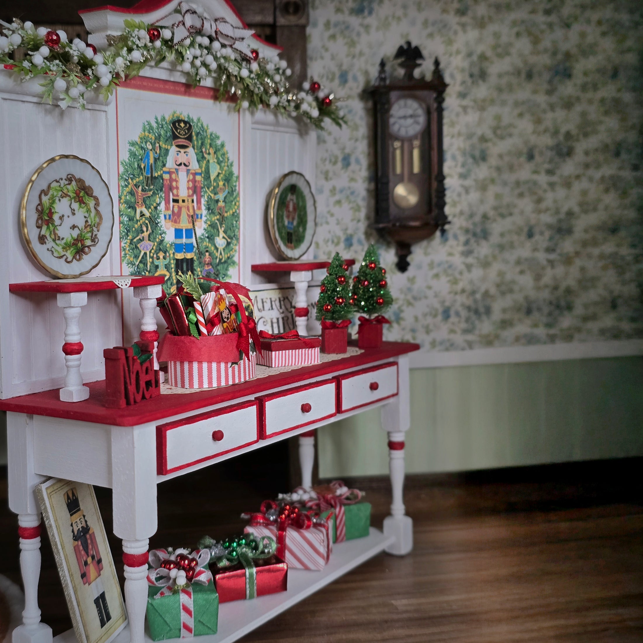 Decorative Christmas setup with a red and white table, nutcracker, and floral wallpaper.