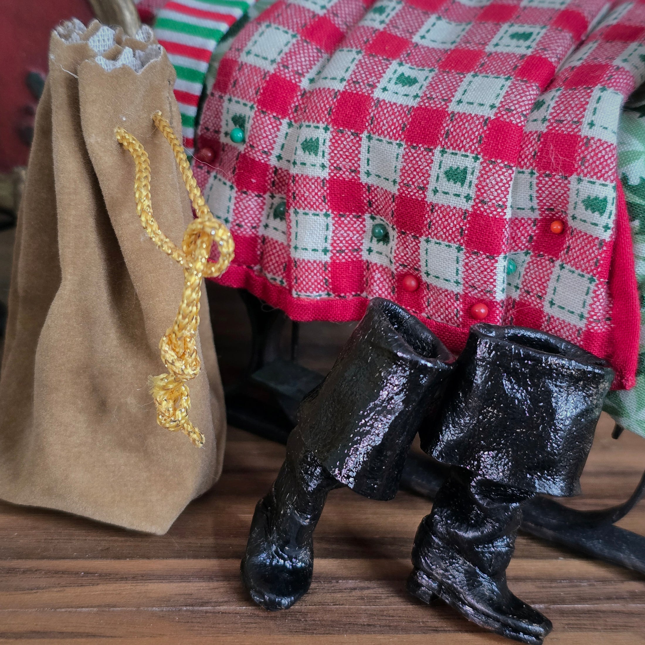 Black boots with an empty toy bag of Santa's