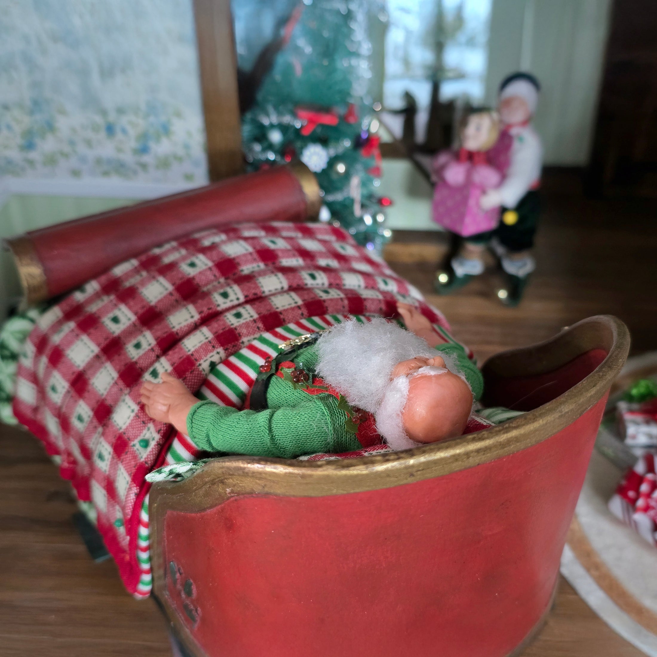 top view of Sleeping miniature dollhouse santa in bed