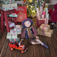 Load image into Gallery viewer, Sculpted clay elf boy doll wearing a purple outfit, Christmas presents, and a small fire truck on a wooden surface.
